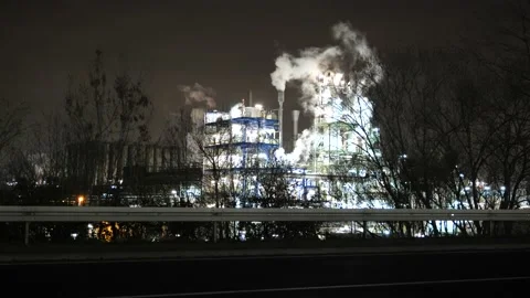 Factory at night - bright light, smoke and cars Stock Footage 152848305