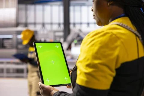 Factory operations with green screen tablet 写真素材