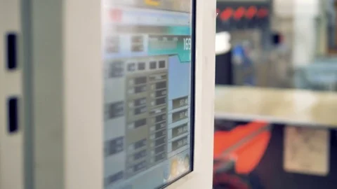 A factory operator changes settings on a press brake screen. Stock Footage 84629631