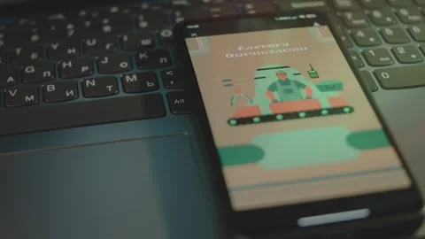 Factory Optimization inscription on smartphone screen. Graphic presentation of a Stock Footage 270939550