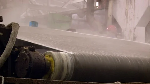 Factory. Papermaking. Sheet of Raw Paper Moving on Conveyer Through Rolls. Stock-Footage 71996734