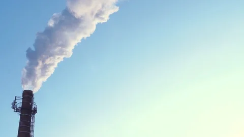 The factory pipe smokes with acrid smoke. Close-up, clear sky. Stock Footage 100803170