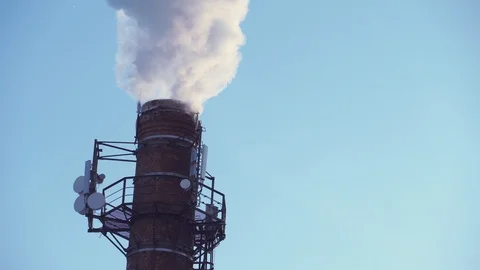 The factory pipe smokes with acrid smoke. Close-up, clear sky. Stock Footage 100803218