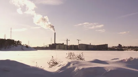 Factory piping out smoke in winter and cranes Video stock 84058623