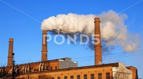 Factory Plant Smoke Stack Over Blue Sky Background