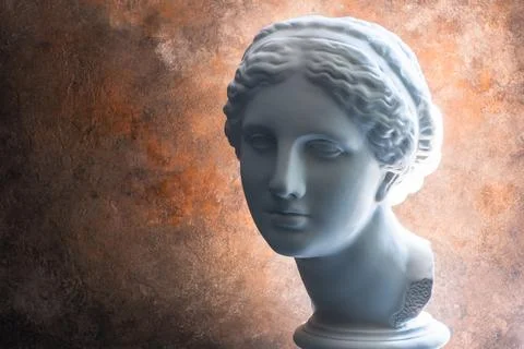 Factory plaster bust of Aphrodite on a rusty antique background with a very b 스톡 사진