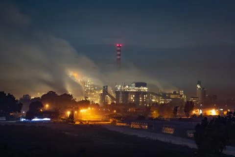A factory polluting at night Stock Photos