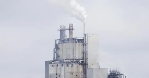A Factory pours a cloud of steam into the sky Stock Footage 253830671