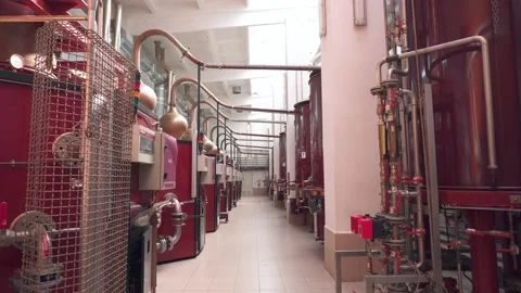 Factory production of brandy. Large tanks of stainless steel and copper Stock Footage 131235166