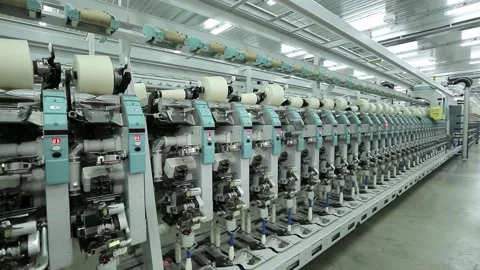 Factory for the production of cotton threads, machines wind the thread on large Video stock 136224974