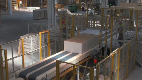 Factory production line. A worker works in a factory. Drywall production. Stock Footage 123060179