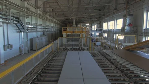 Factory production line. A worker works in a factory. Drywall production. Stock Footage 123063323