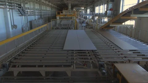 Factory production line. A worker works in a factory. Drywall production. Stock Footage 123063353
