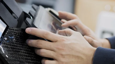 Factory for the production of robots. Engineer adjusts the keyboard. Creates Stock Footage 102151137