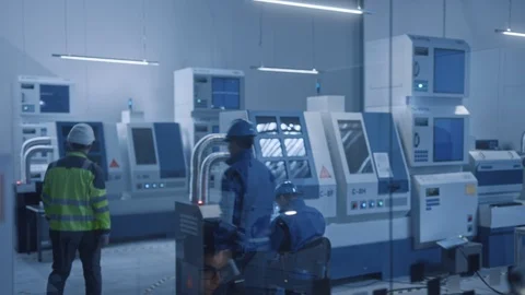 In Factory: Professionals Working on CNC Machinery and Robot Arm Production Line Stock Footage 126153258