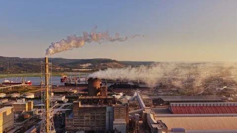 Factory scene with smokestacks and river view during sunset Stock Footage 340384507