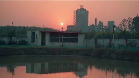 Factory silhouette at sunset with water reflection industrial scene 스톡 동영상 332920993