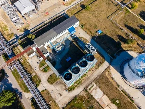 A factory site featuring several cooling towers and various industrial buildi Stock Photos