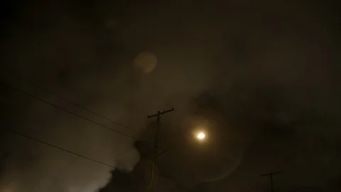 Factory smoke night sky with street lamp and telephone lines in foreground Stock Footage 89945357