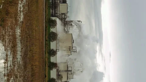 Factory smoke stack and pipes puff into air Stock Footage 91149966