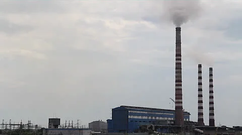 Factory smoke stack exhausting smoke into the sky Stock Footage 25937275