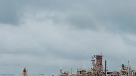 Factory with smoke stacks against cloudy sky 스톡 동영상 40254768