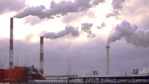 Factory with smoking chimneys against background of clouds and sunset sky. Stock Footage 233244591
