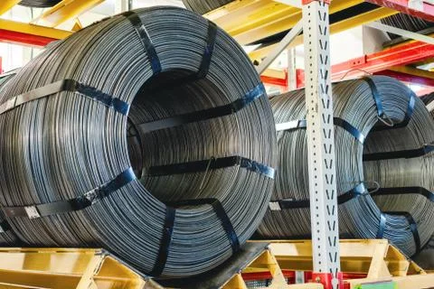 Factory stock wire. Wire spools lie on multi-tiered racks. Stock Photos