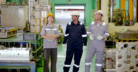 Factory supervisor and two technicians stand in slow motion during shop floor Stock Footage 335115185