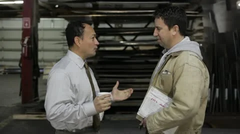 Factory supervisor talking to the foreman Stock Footage