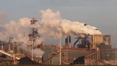 Factory Tata Steel with smoking chimneys on a sunny day, IJmuiden, The  Netherlands Stock Photo