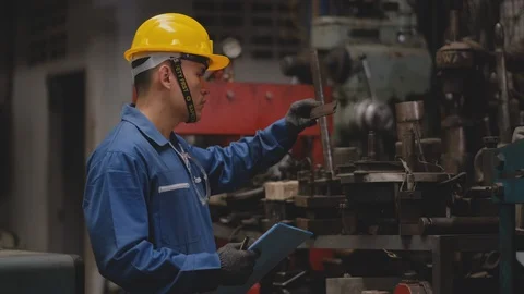 Factory technician or worker with yellow helmet and blue uniform check tools Stock Footage 127809818