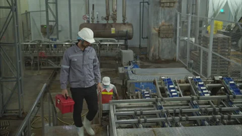 Factory technicians perform routine machinery inspections Stock Footage 308316197