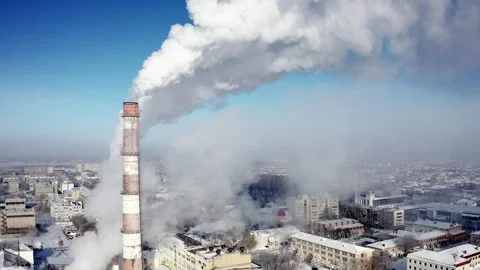 The factory tower smokes on the winter city Video stock 156599982