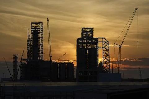 A factory under construction against the background of the evening sky Stock Photos