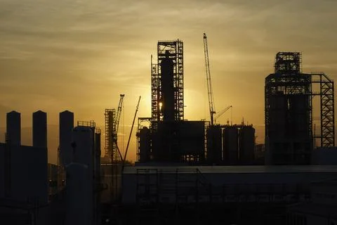 A factory under construction against the background of the evening sky Stock Photos