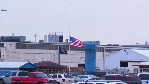Factory w American flag at half mast &amp; UAW flag Stock Footage 139121389