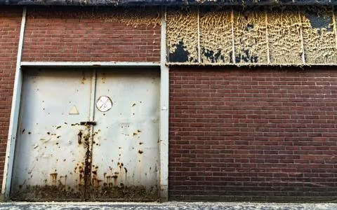 A factory wall falling apart Stock Photos