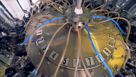 A factory washing machine cleans empty vodka bottles. 4K. Stock Footage 88402846