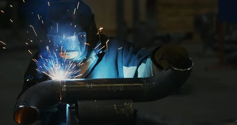 Factory welder welds pipe Stock Footage 104029508