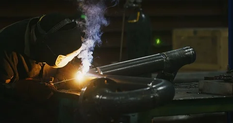 Factory welder welds pipe Stock Footage 104031244
