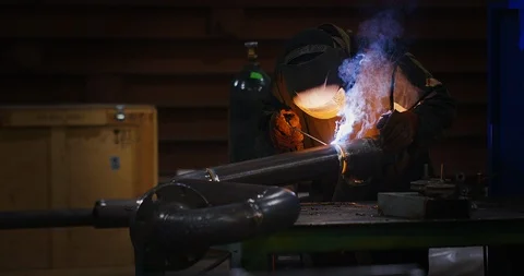 Factory welder welds pipe Stock Footage 104031255