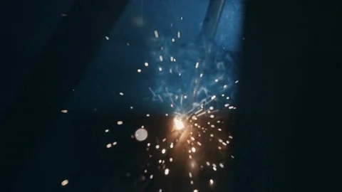 Factory welding, slow motion, blue and yellow bright sparks, black background Stock Footage 127650565