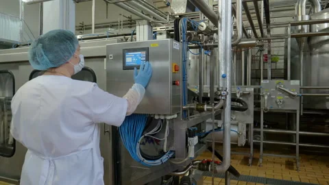 Factory Woman press buttons on computer screen to launch industrial line Video stock 131086546