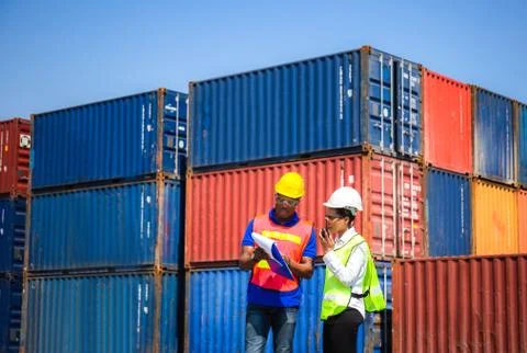 Factory worker and foreman team control loading containers box from cargo 스톡 사진
