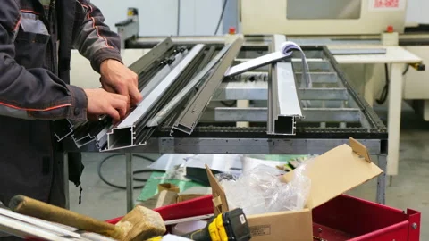 Factory worker assembling aluminum window frame Stock Footage 317099303
