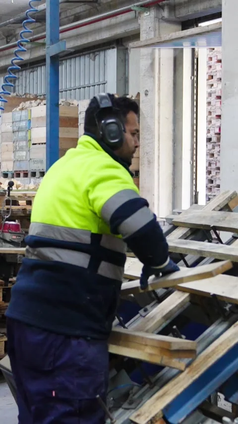 Factory worker assembling wooden pallets in slow motion Stock Footage 313924388