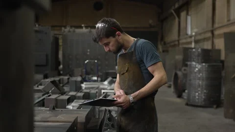 Factory worker checking metal parts inventory Video stock 334723086