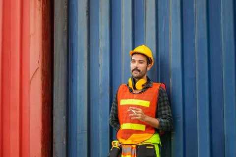 Factory worker with a cigarette smoke break, Labour takes a cigarette break Фото