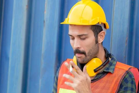Factory worker with a cigarette smoke break, Labour takes a cigarette break 库存照片